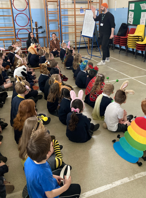 young primary pupils dressed for book day engage with author