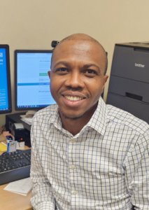 Dr.Olumide Ayodele GP Partner, Coltishall & Spixworth Surgeries at his desk